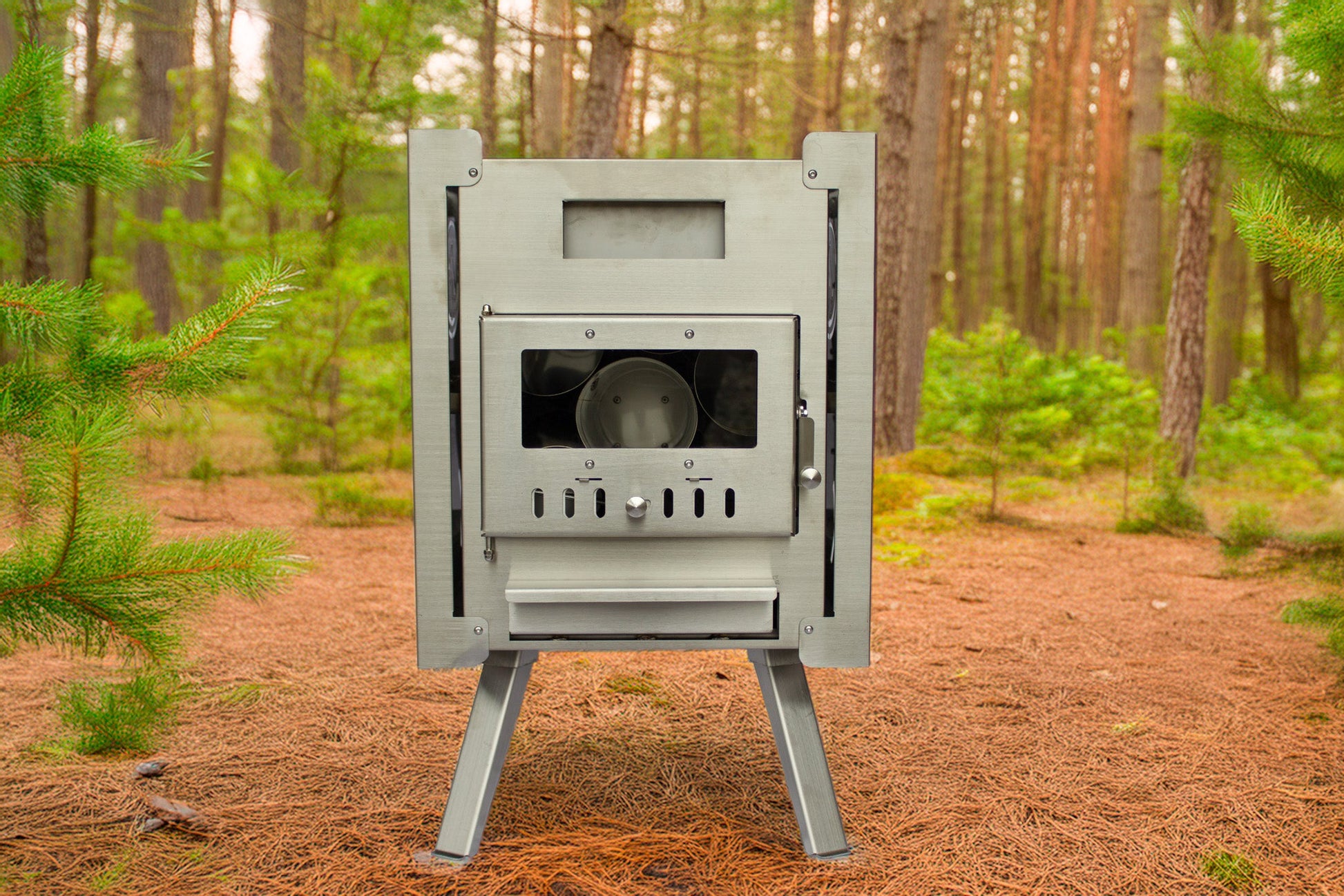 Wood-fired stainless-steel stove for Nova 6 Sauna Tent Premium Package (6-person) in a forest setting.