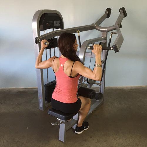Side view of woman training on Classic Lat Pulldown Machine by Muscle D Fitness seated