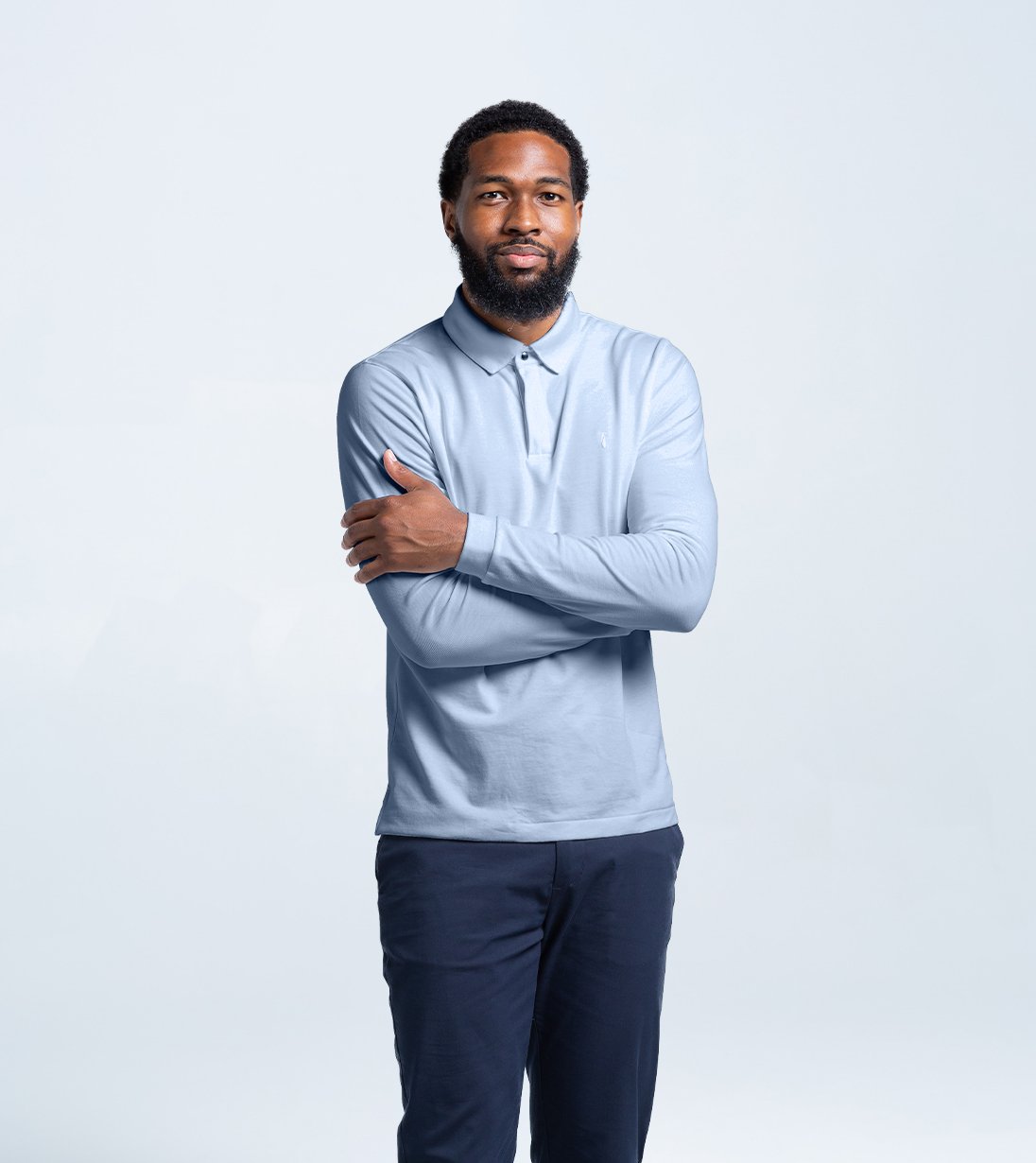 Model wearing Long Sleeve Perfect Polo with StaySharp™ Collar, four-way stretch, and hidden microfiber cloth in light blue.