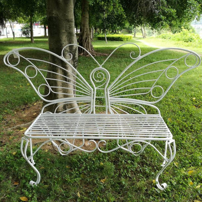 Modern Outdoor Butterfly Garden Bench in White Metal Finish in a lush garden setting