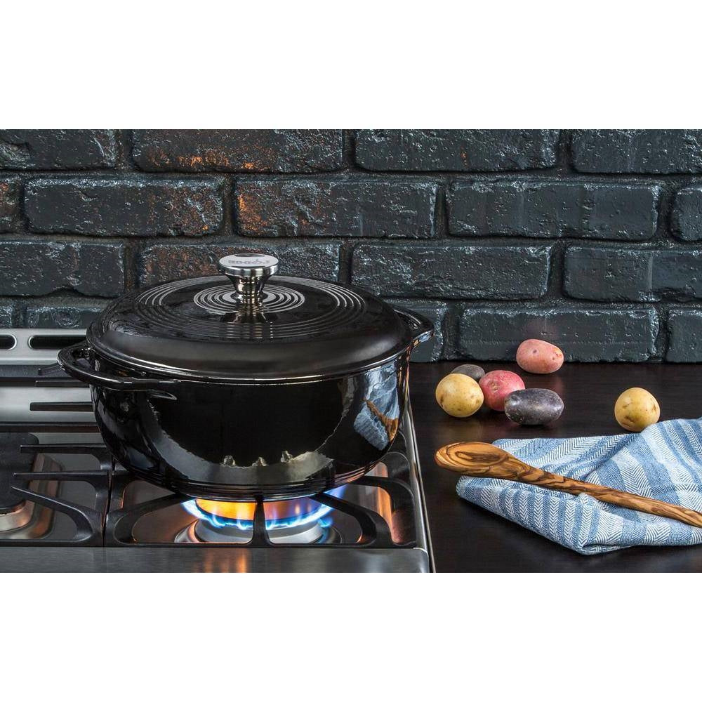 Round 6-Quart Black Enamel Cast Iron Dutch Oven with Lid on stove.