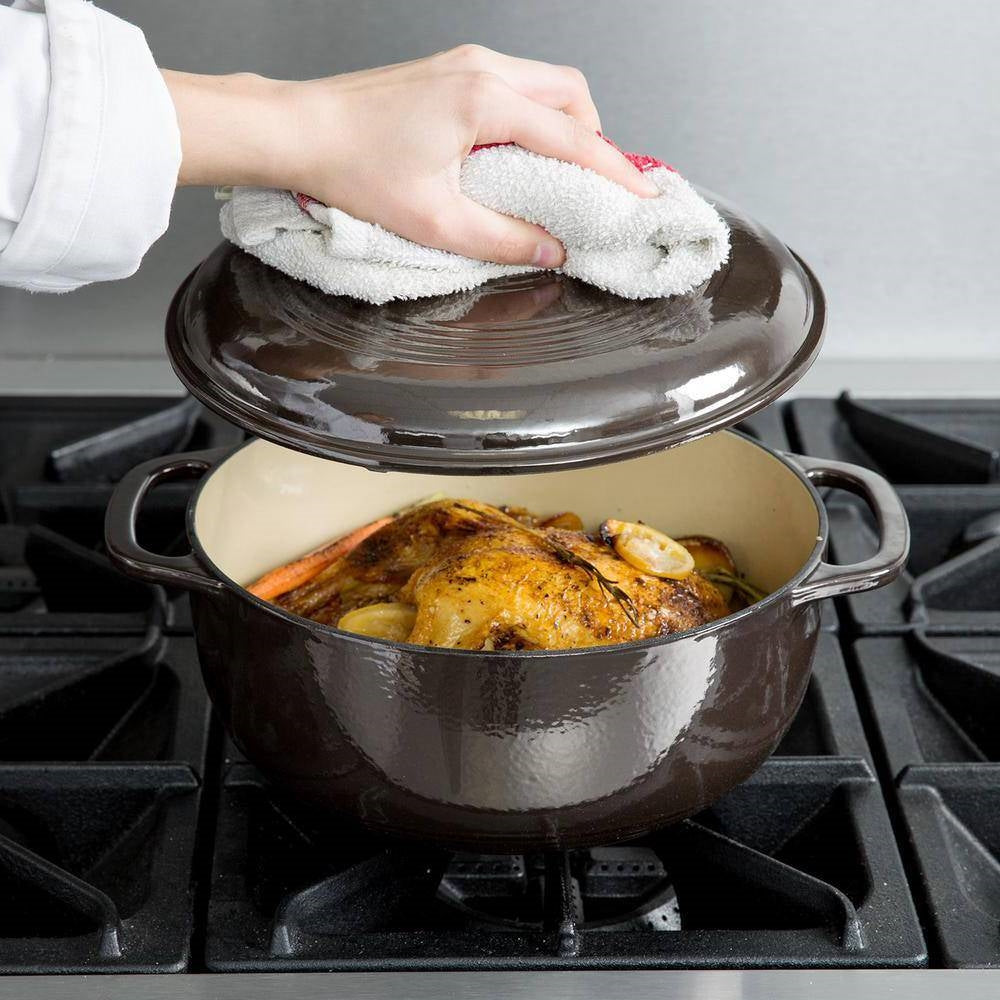 Cooking with Round 6-Quart Black Enamel Cast Iron Dutch Oven with Lid, filled with a roasted chicken on stovetop.