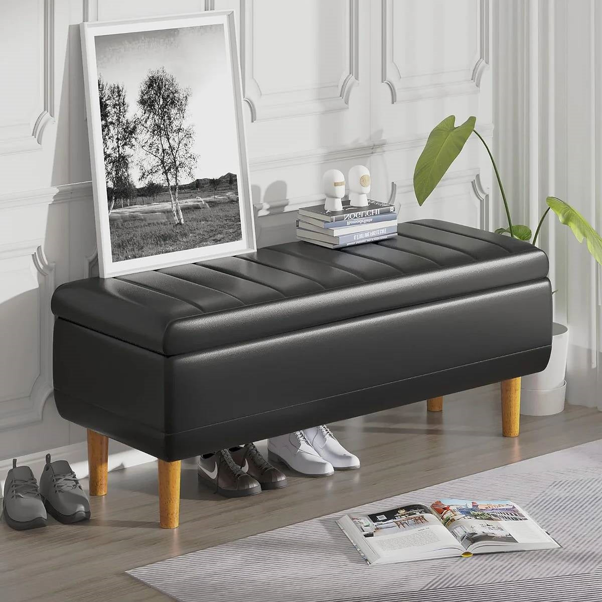 Modern Mid-Century Black Faux Leather End of Bed Storage Bench Ottoman in stylish bedroom setting.