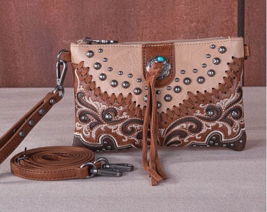 Tassel Western Clutch & Crossbody Bag with leather whipstitch, turquoise concho, silver studs, and scroll design embroidery.