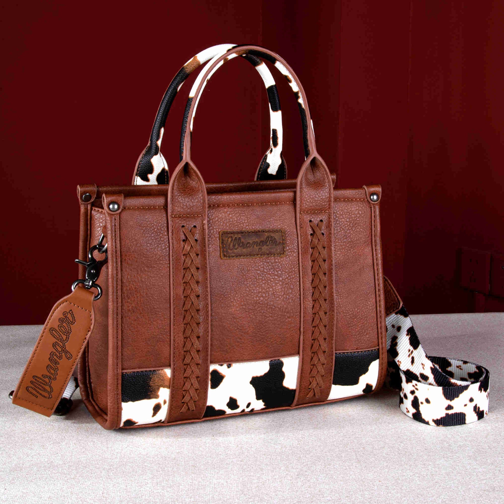 Wrangler Cow Print Concealed Carry Tote/Crossbody - Brown with whipstitch detail and cow print design.