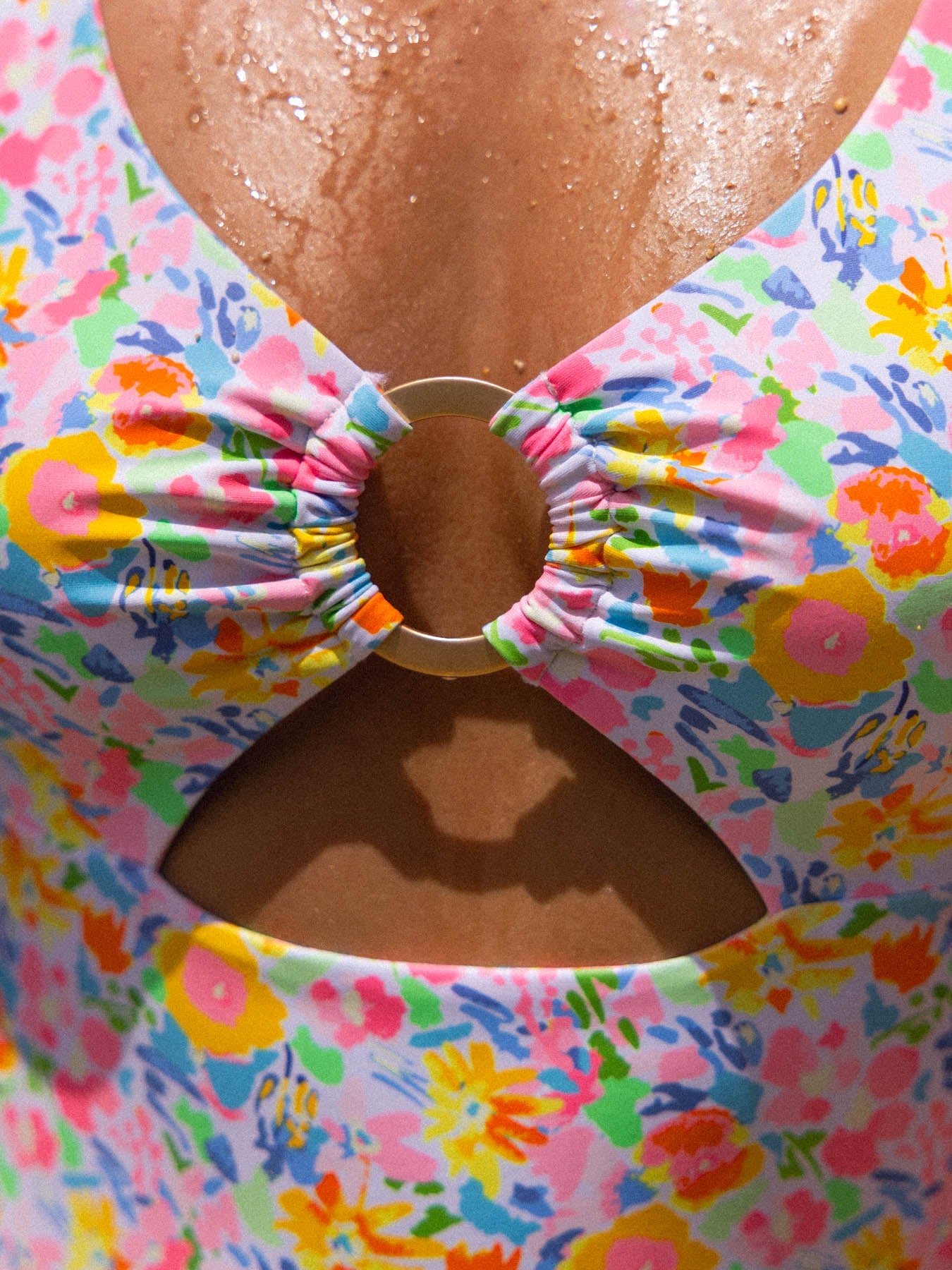 Close-up of floral randi one piece - monaco swimsuit with center ring and keyhole design, featuring vibrant colors and supportive tie back.