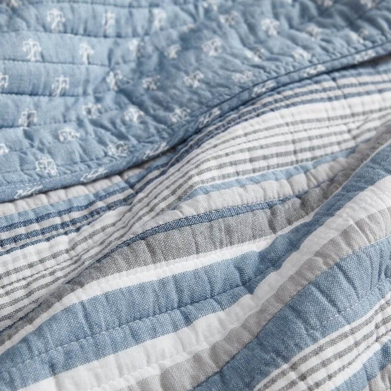 Close-up of Twin 2 Piece Nautical Anchor Blues 100-Percent Cotton Reversible Quilt Set with anchor and stripe design.