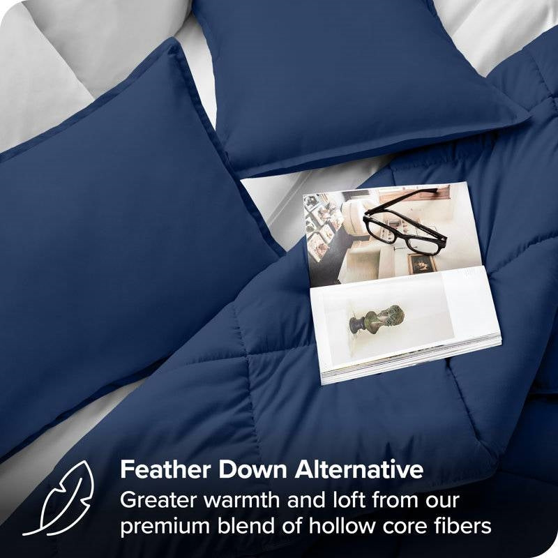 Full/Double size Super Soft Down Alternative Comforter Set in Navy Blue displayed with pillows and a magazine on a bed