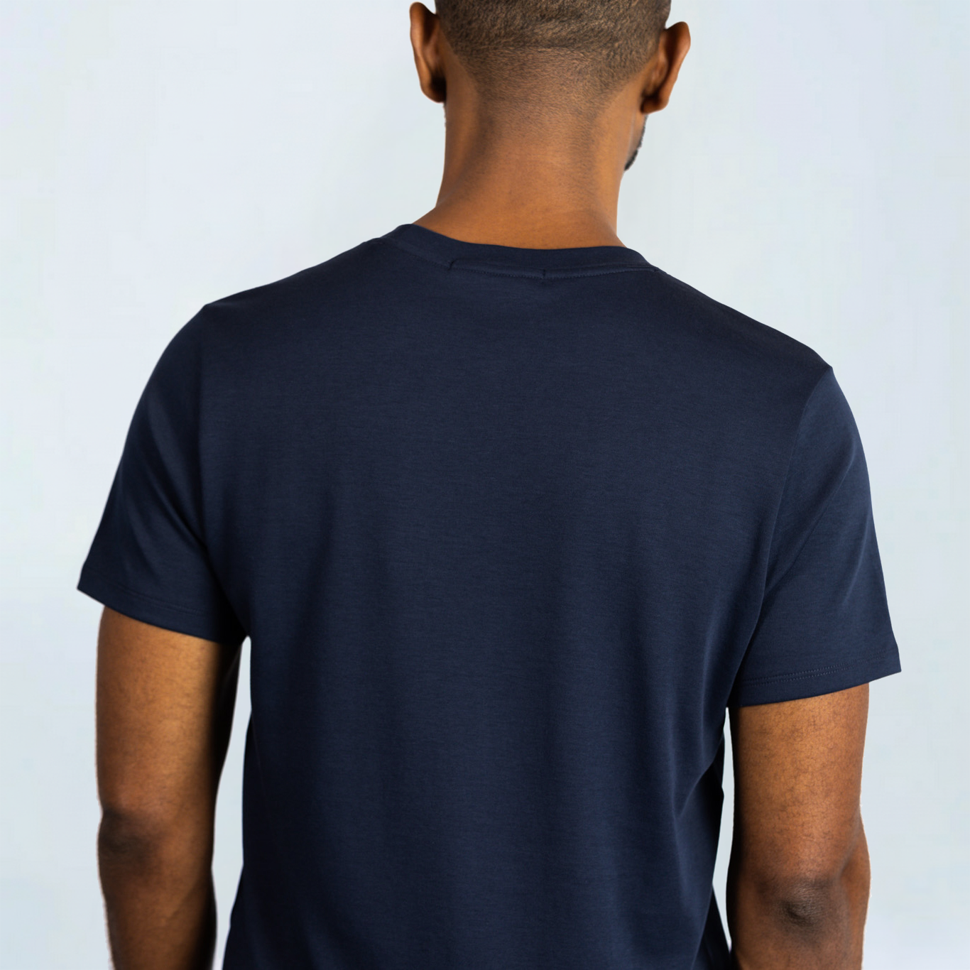 Back view of Short Sleeve Perfect Tee in navy blue, crafted from Peruvian Pima cotton, showing wrinkle-resistant fabric.
