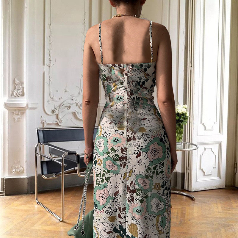 Rear view of Women's Printed Backless Slit Sling Dress with floral pattern and slim straps in an elegant room.