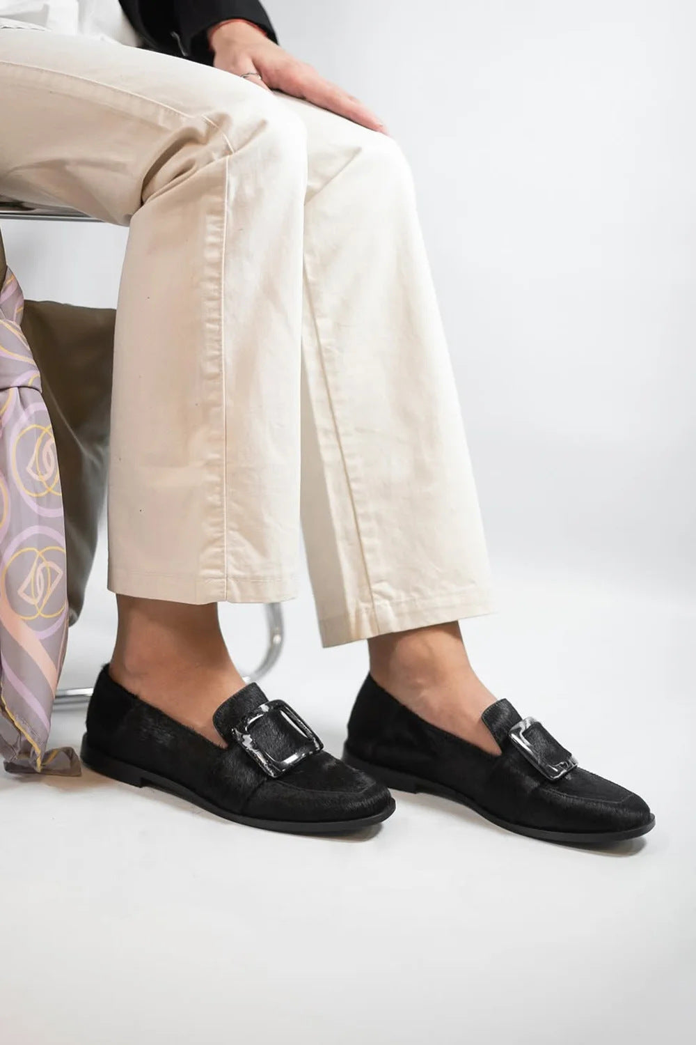 Woman wearing Vintage Square-Button Low-Cut Loafers — Women’s Elegant Slip-On Shoes with black square button detail, sitting on a chair.