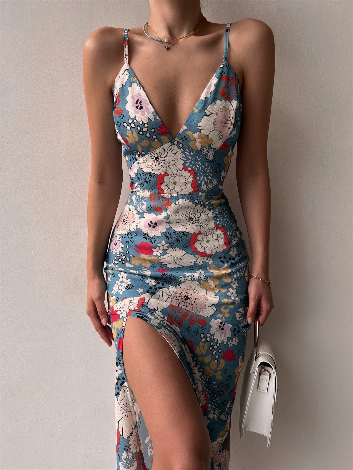 Model wearing a Women's Printed Backless Slit Sling Dress with floral print, featuring a low-cut back and side slit.