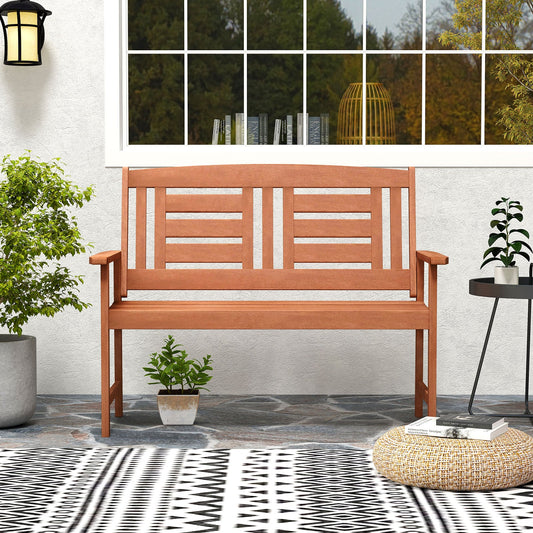 Outdoor Solid Wood Loveseat Hardwood 2-Seat Bench with Inclined Backrest and Slatted Seat on patio with plants