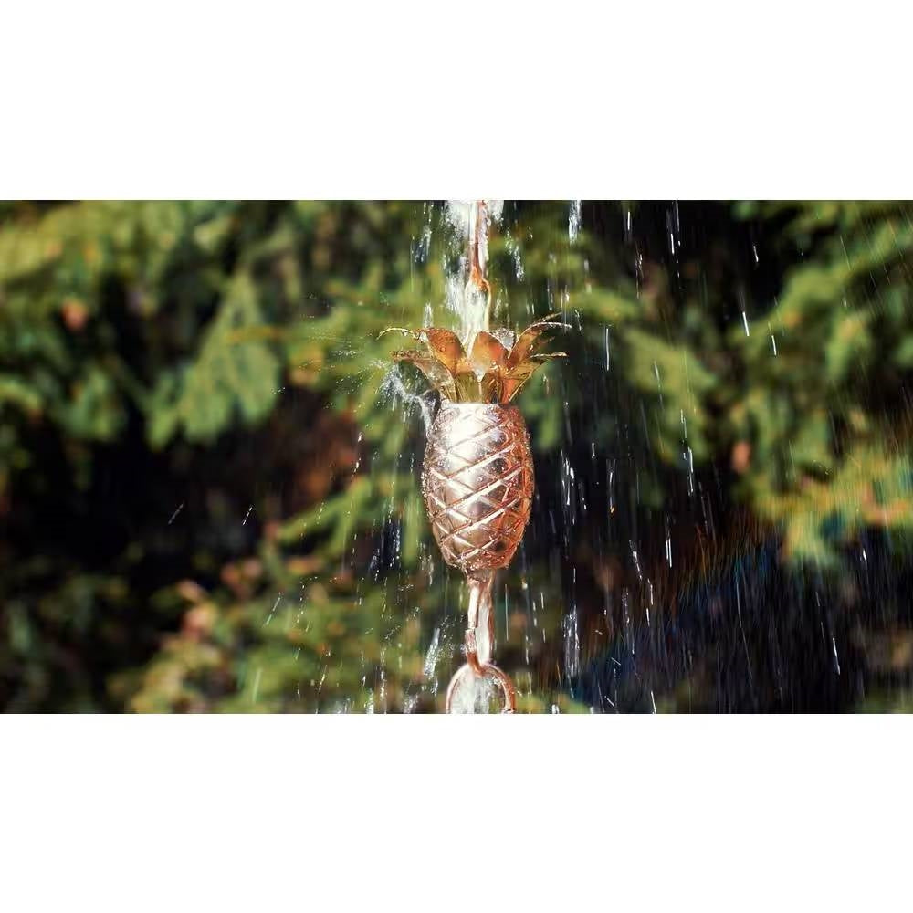 8.5 Ft. Copper Pineapple Rain Chain Gutter Downspout - Basin Not Included with water cascading in a garden setting