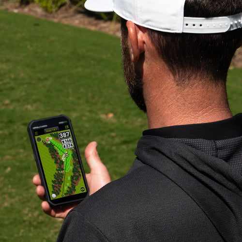 Golfer using SkyCaddie® PRO 5X with TruePoint Precision Positioning Technology on the golf course.
