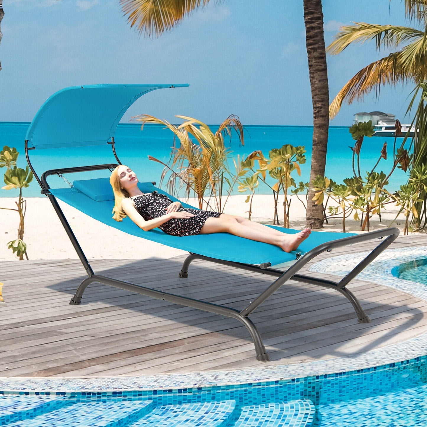 Patio Hanging Chaise Lounge Chair with Canopy Cushion Pillow and Storage Bag-Navy on a tropical deck by the beach