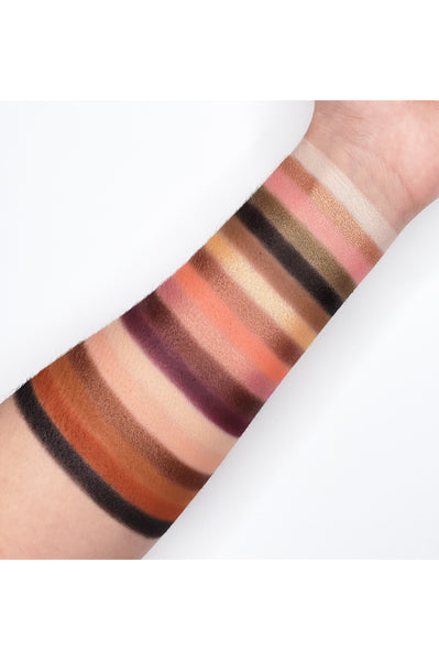 Swatches of Go2 PEACH SANGRIA - GES08 eye palette showcasing peachy pinks, corals, bronze, and plum tones on an arm.