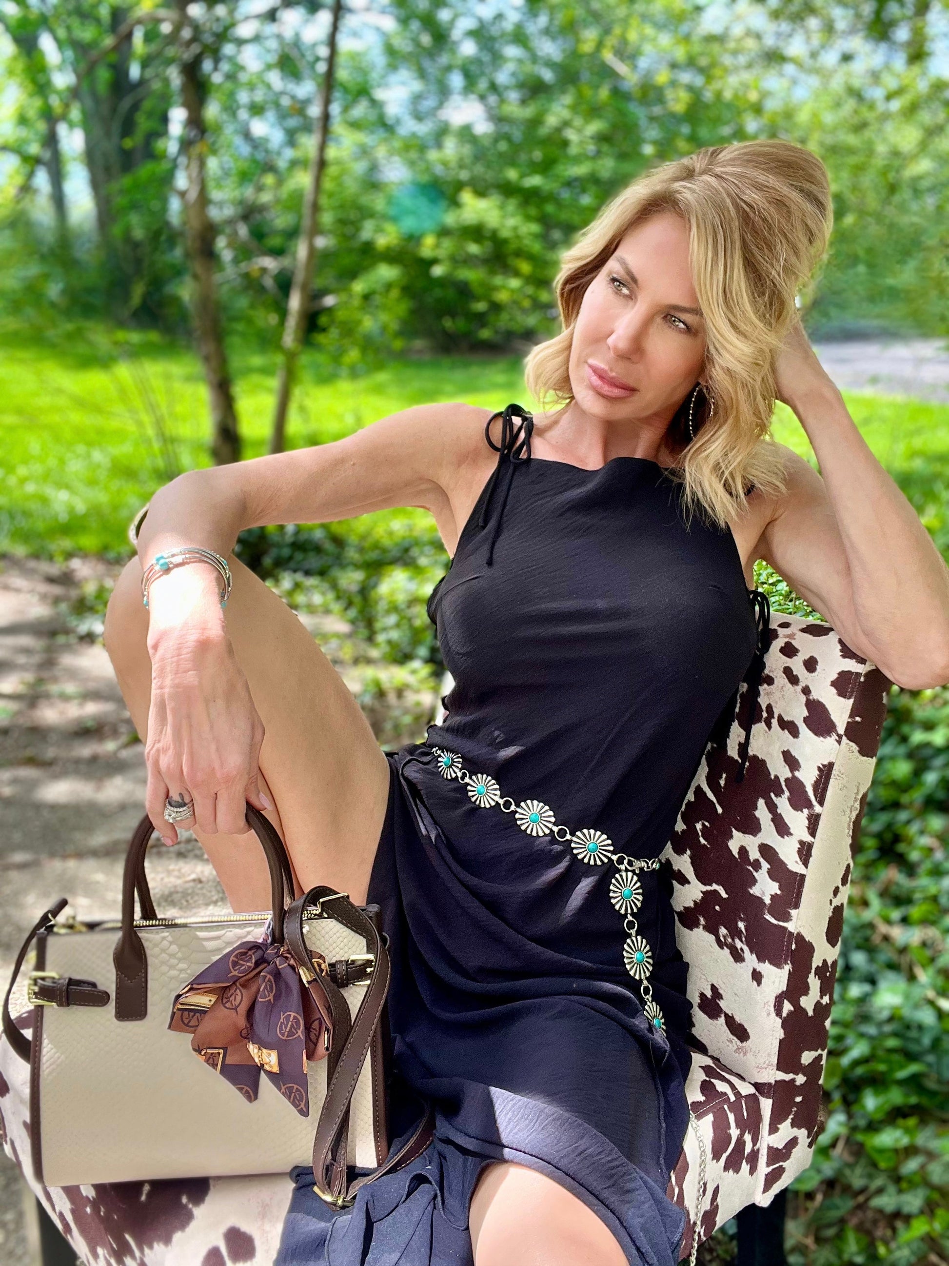 Woman sitting outdoors with Serpent Luxe Snakeskin Handbag - Elegant Leather Commuter Bag for Stylish Women, showcasing luxury fashion.