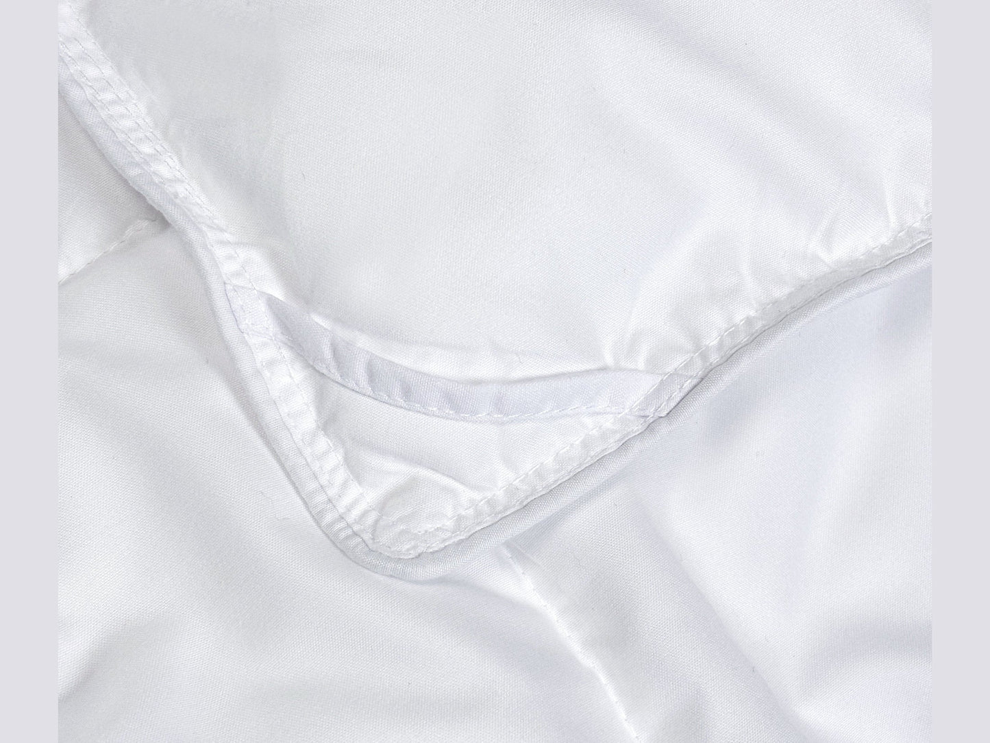 Close-up of SHNUGGLE SNAP-EZ Quilt showing snap-on detail and soft fabric.