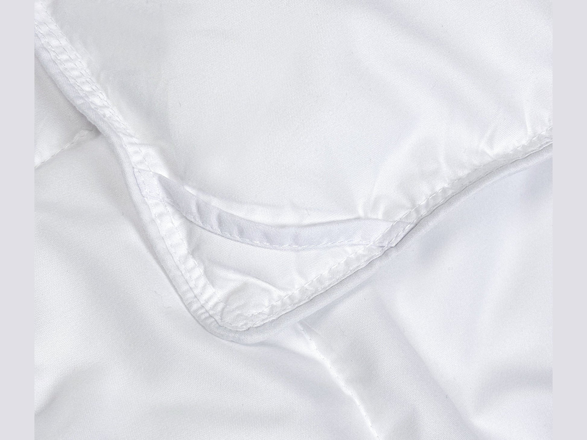 Close-up of SHNUGGLE SNAP-EZ Quilt showing snap-on detail and soft fabric.