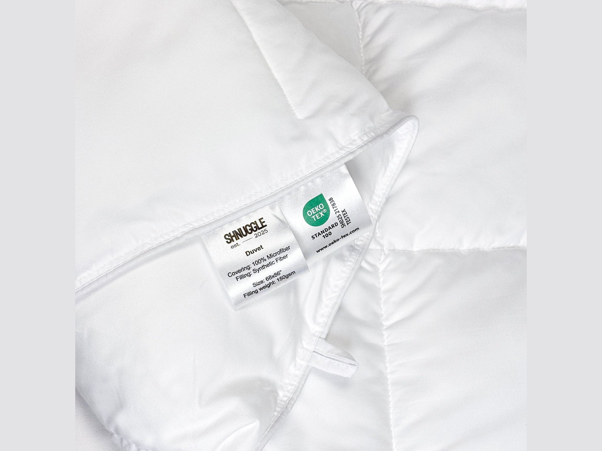 Close-up of SHNUGGLE SNAP-EZ Quilt label showing washing instructions, emphasizing its ease of care and practicality.