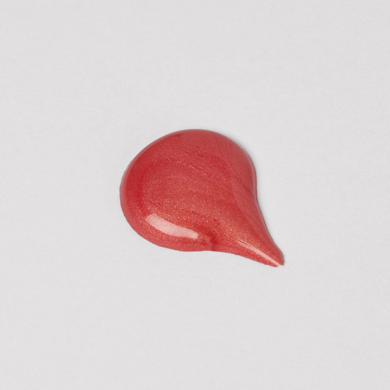 Swatch of Lip Gloss Wand showing soft-touch, high-shine vegan finish in pink tone.