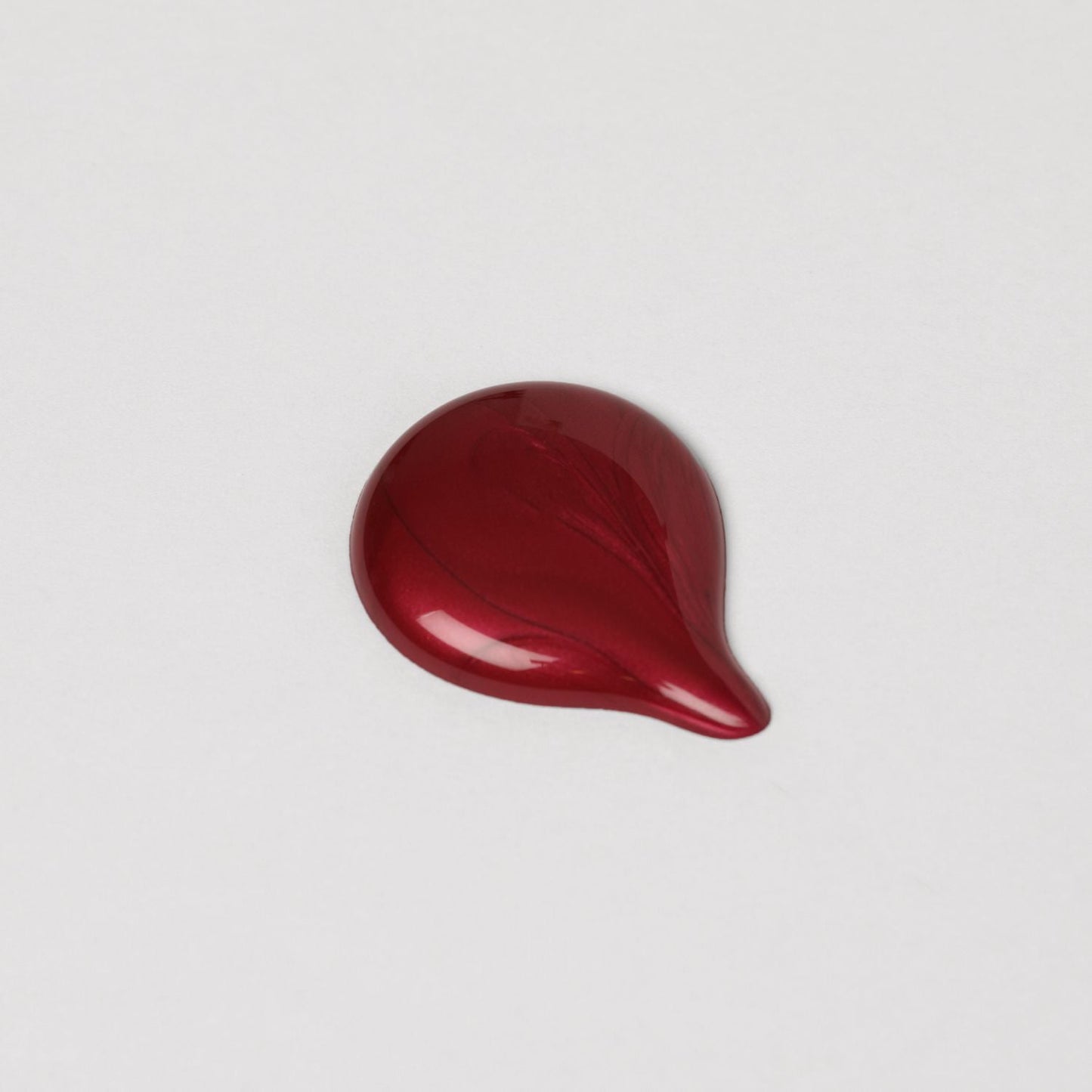 Rich red swatch of Lip Gloss Wand showing high-shine gloss finish.