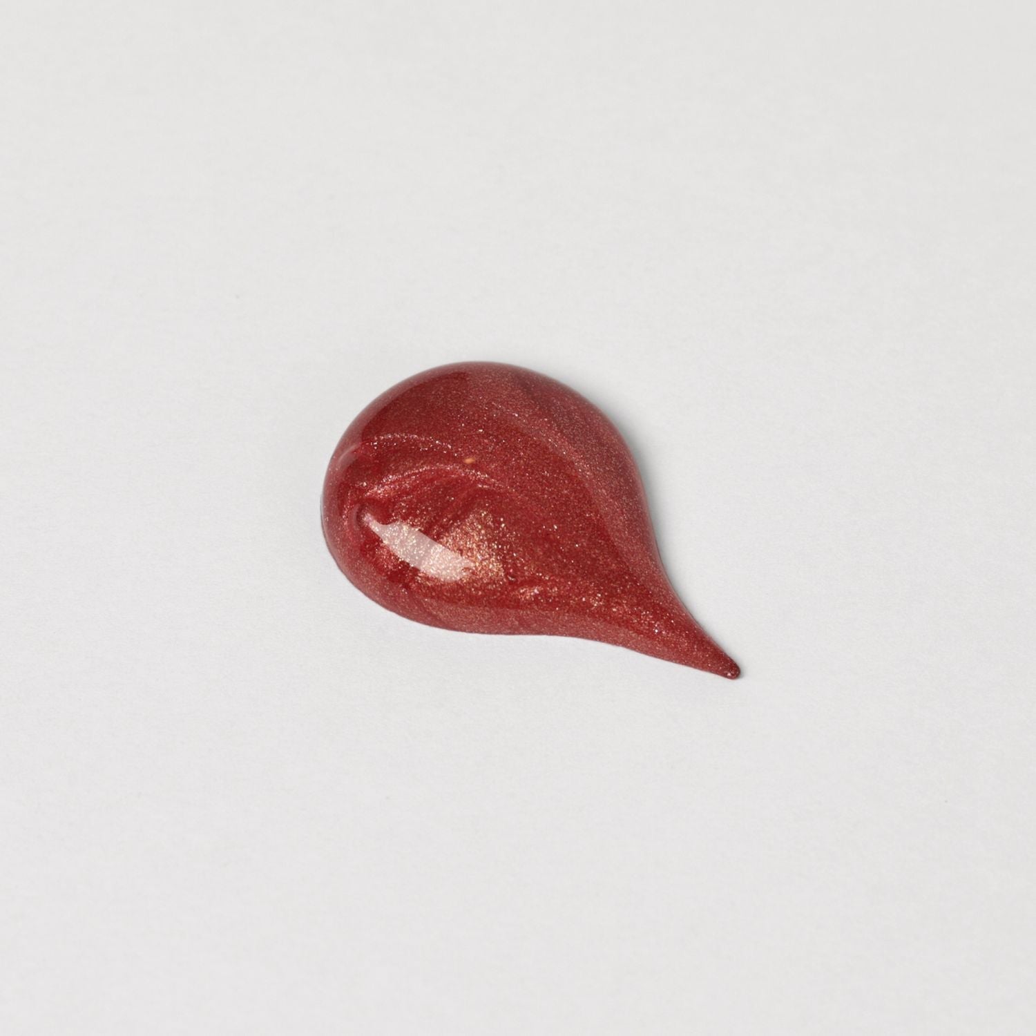 Red Lip Gloss Wand swatch showing glossy, dimensional sheen for nourished lips