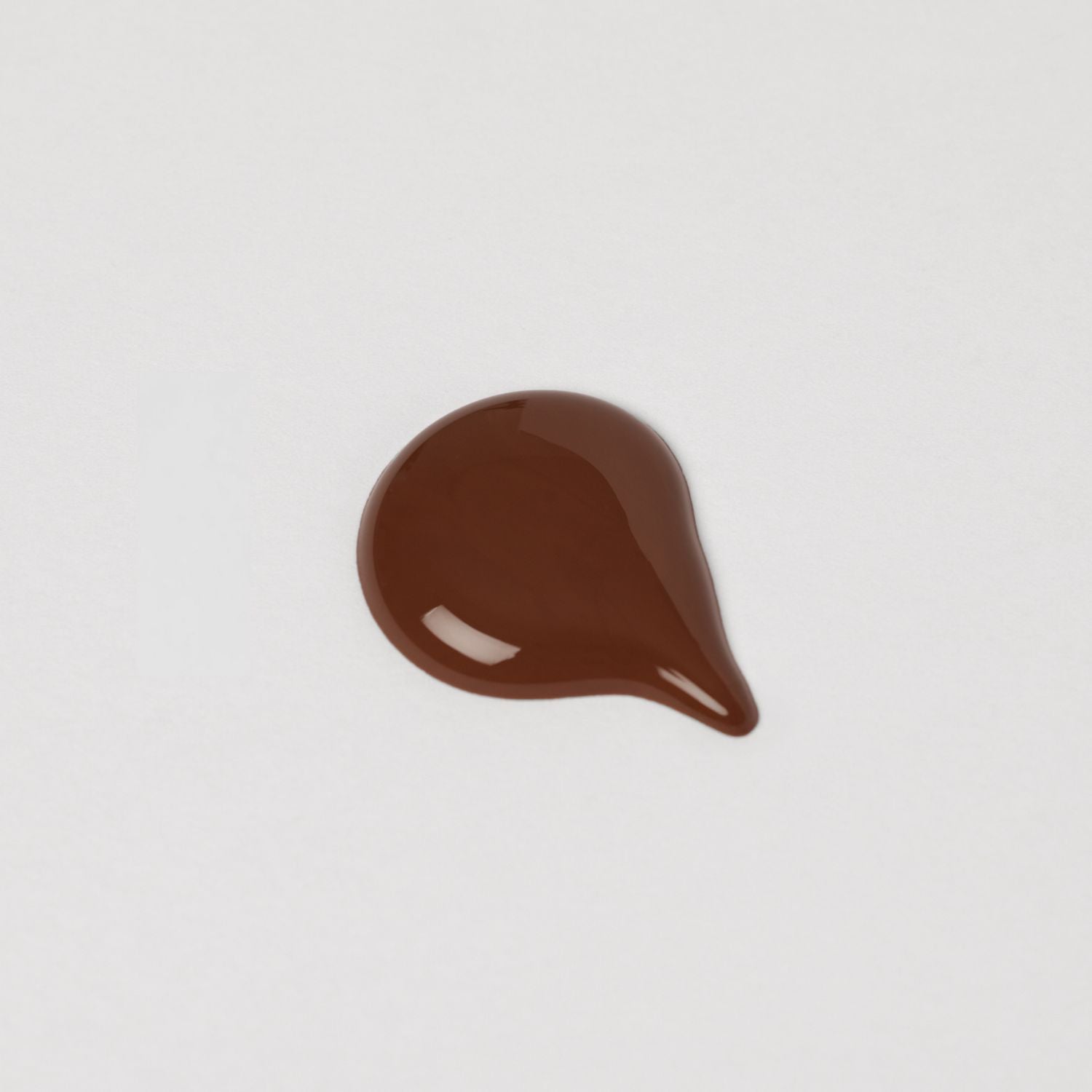 Swatch of Lip Gloss Wand showing rich brown hue with a glossy finish, highlighting the vegan formula for nourished, smooth lips.
