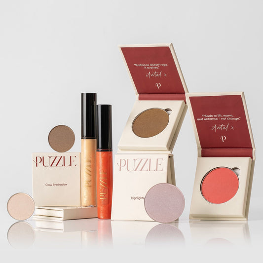 The Glow & Go Set featuring various beauty products including eyeshadow, lip gloss, and highlighter for radiant, luminous beauty.