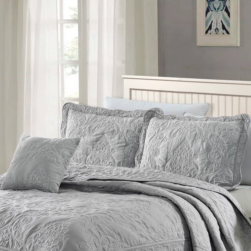 Queen size Ash Grey Damask Embroidered 4 Piece Oversized Bedspread Set displayed on a bed in a sunlit room.