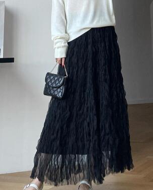 Woman wearing a black Midi Mesh Skirt with elegant layered tulle design, styled for a chic, sophisticated look.