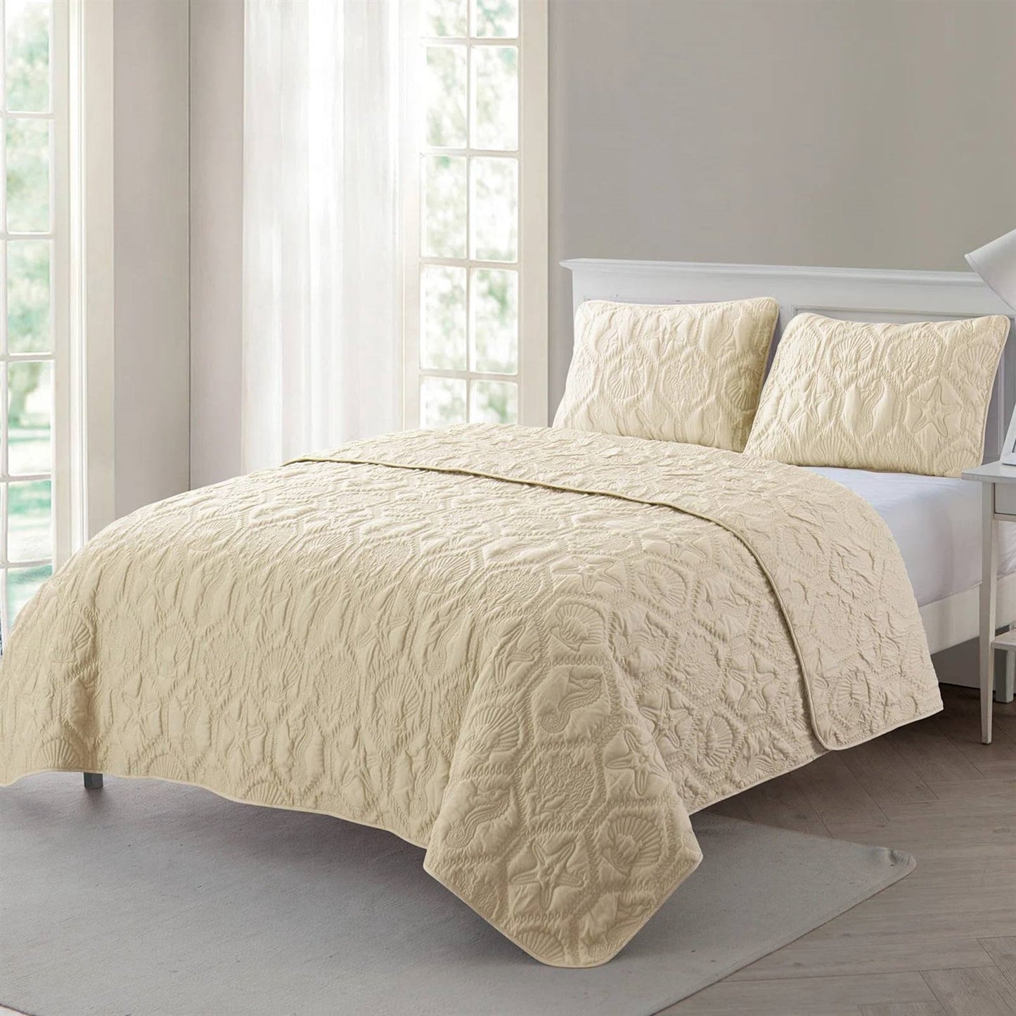Queen Coastal Beach Starfish Seashells Seahorse Sand Tan 3-Piece Quilt Set laid out in a bedroom setting
