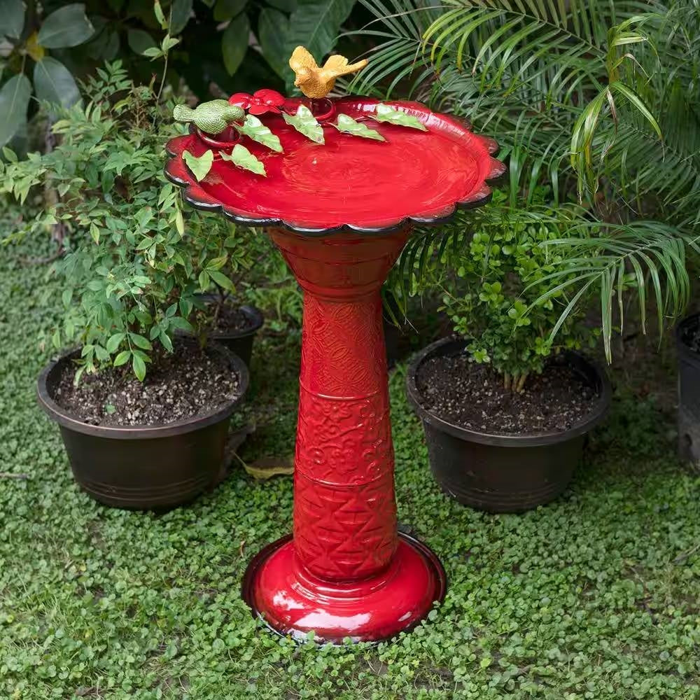 Red Metal Outdoor Garden Patio Birdbath with Decorative Bird Leaf Figurines in a lush garden setting.
