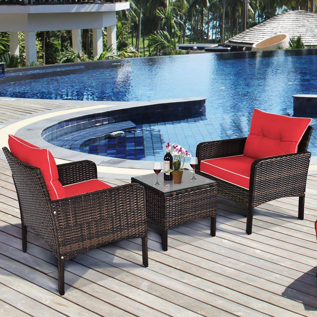3-Piece Brown PE Rattan Outdoor Dining Patio Furniture Set with Red Cushions by a poolside deck
