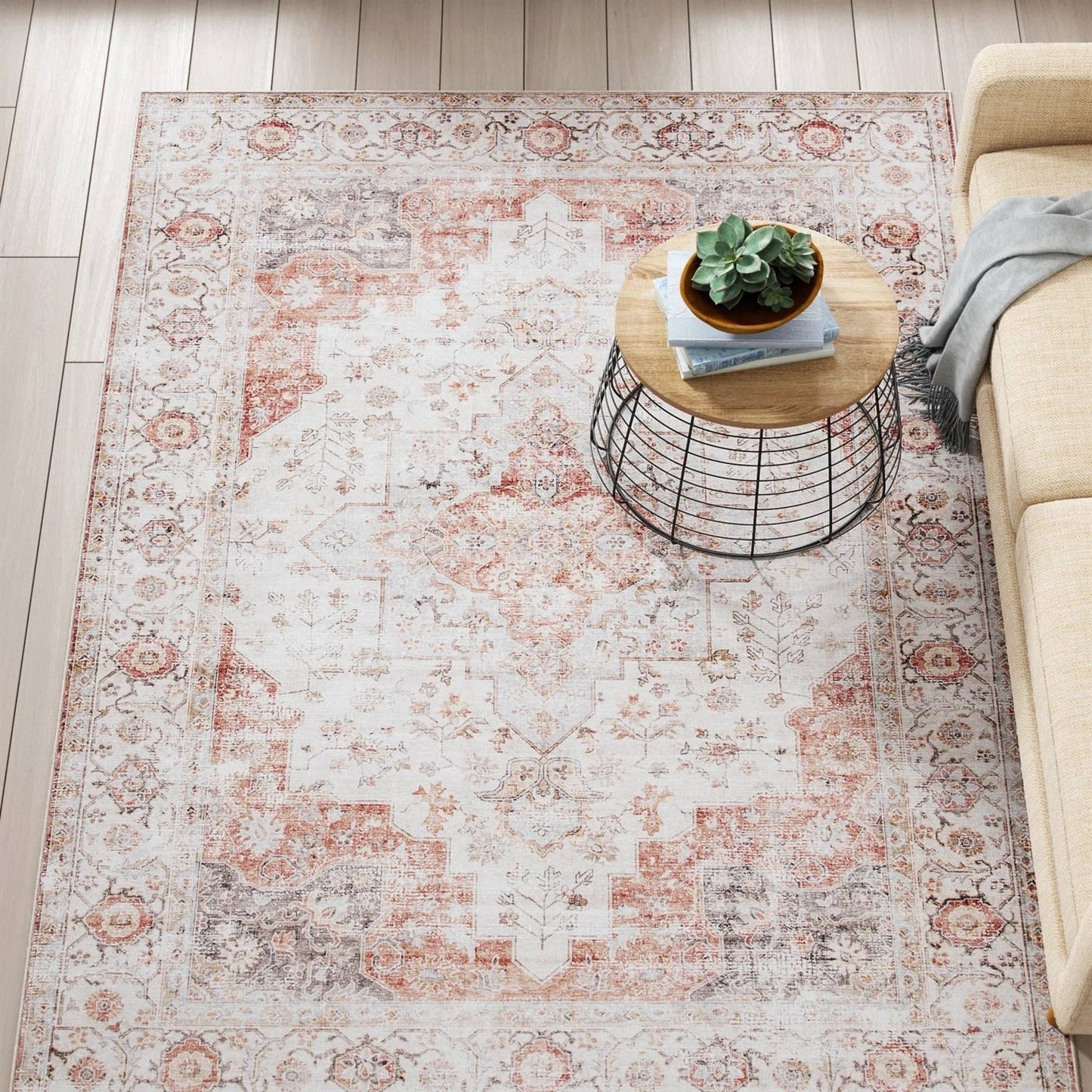 6 ft. x 9 ft. Traditional Persian Style Washable Boho Light Grey Red Area Rug in living room with coffee table on it