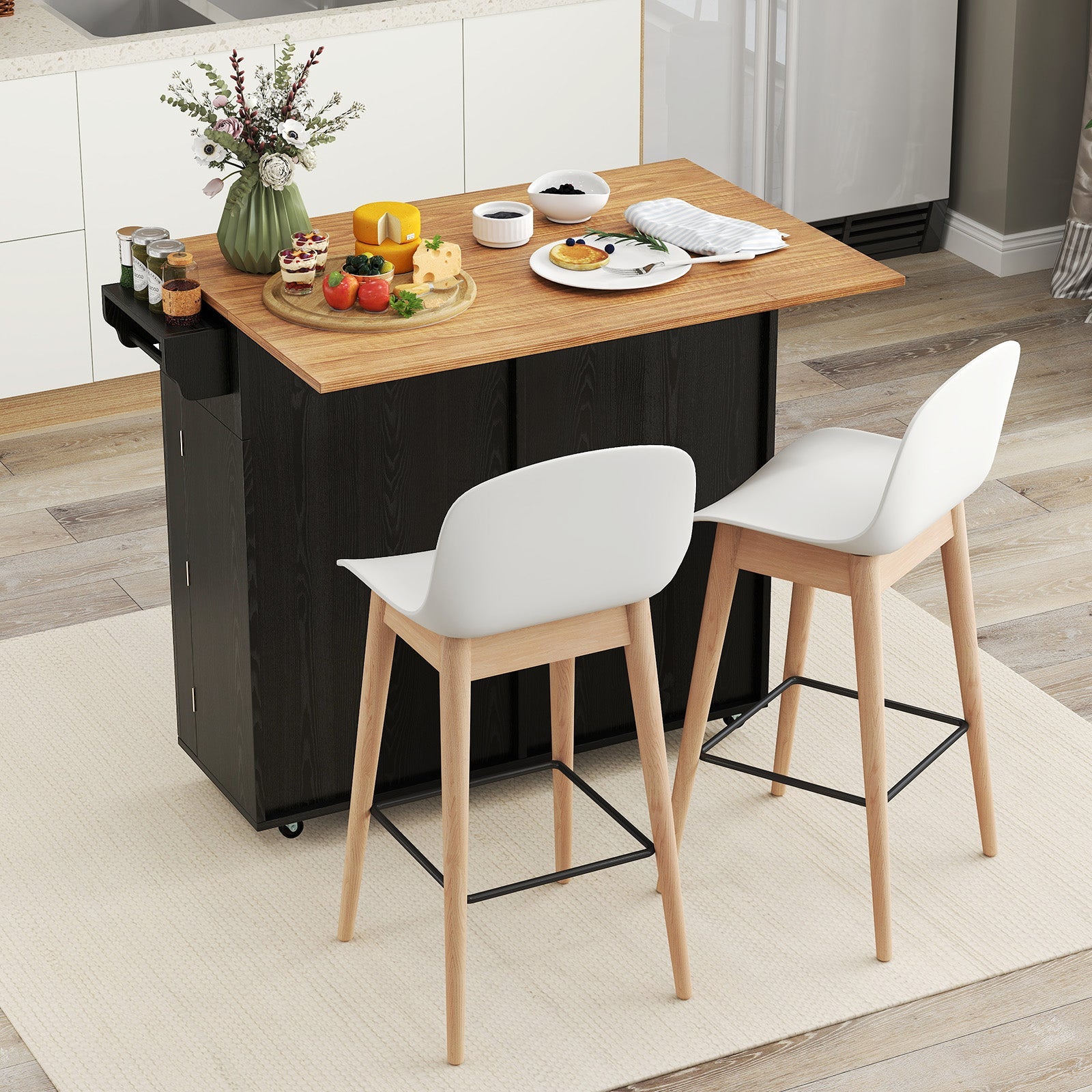 Rolling Kitchen Island with Trash Can Cabinet and Rubber Universal Wheels-Black in a modern kitchen setting with dishes on top.
