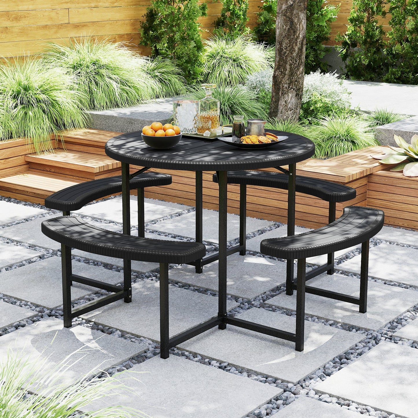 Round Picnic Table Bench Set with 4 Benches and Umbrella Hole for Patio Lawn-Black in garden setting