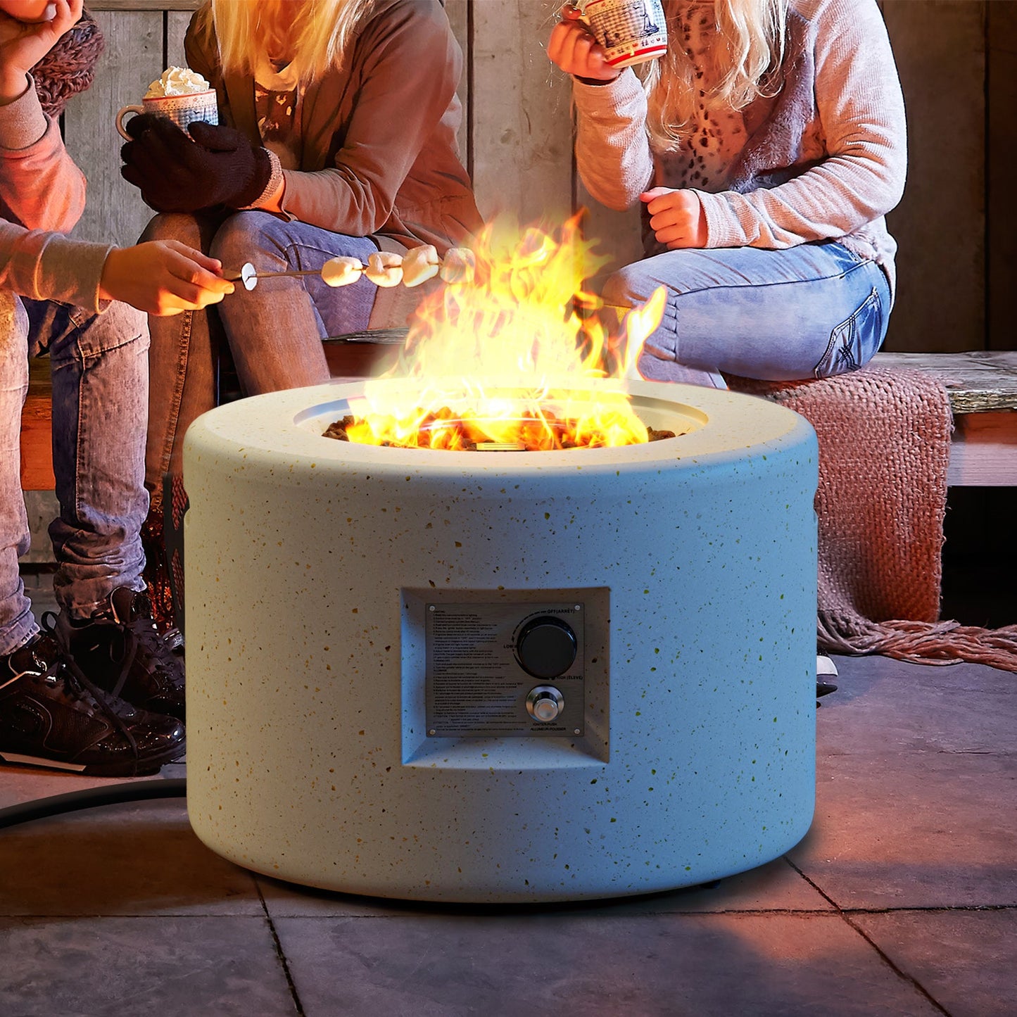 Round Terrazzo Propane Gas Fire Pit with Hideaway Tank Holder and Lava Rocks in use on a cozy patio setting