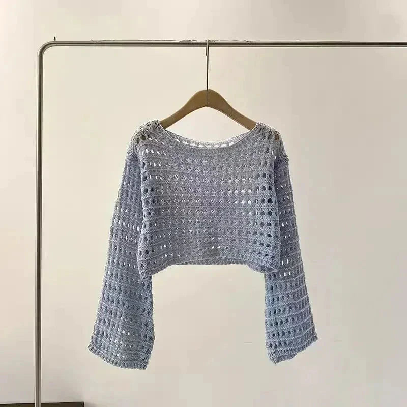 Women’s crochet knit beach cover up on hanger, boho chic long sleeve top, ideal for vacations and summer festivals.