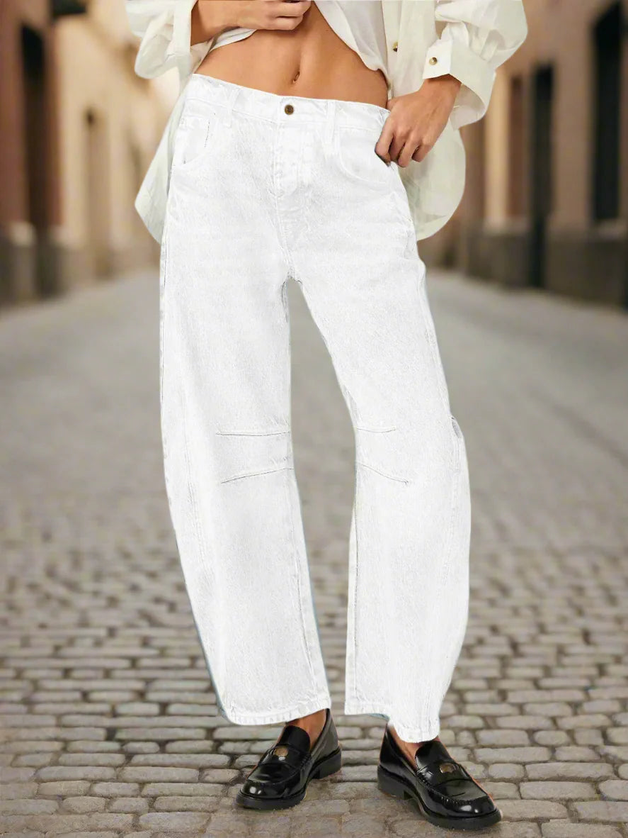 Woman wearing Women’s Elastic Waist High Waisted Jeans with loose fit and cropped cut in urban setting.