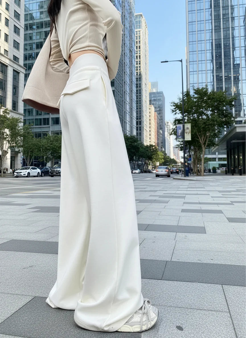 Woman wearing Gray High-Waist Loose Wide-Leg Straight Pants Women, standing on a city sidewalk, modern high-rise buildings in background.