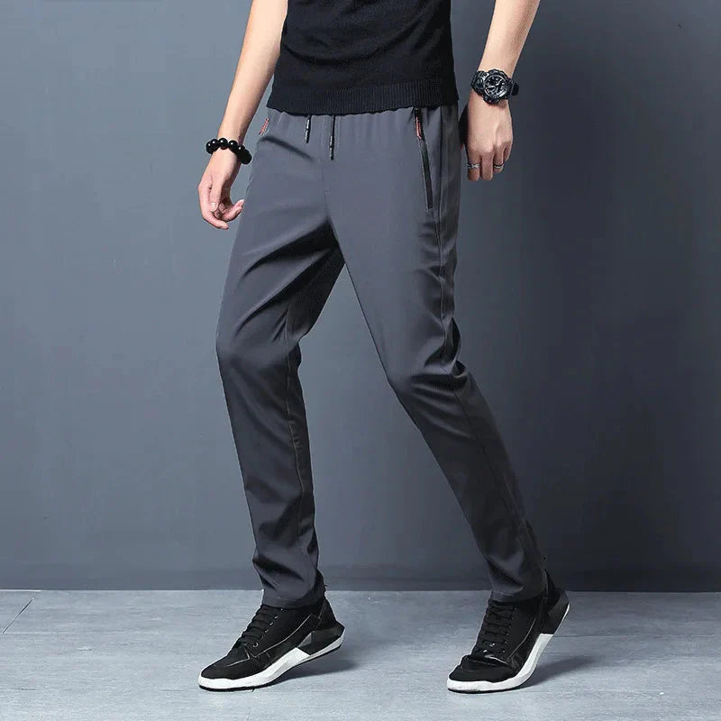 Person wearing gray Slim Fit Stretch Jogger Pants with Elastic Waist
