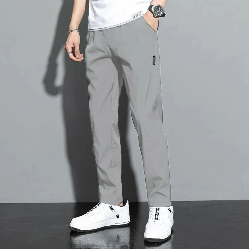 Slim Fit Stretch Jogger Pants with Elastic Waist in gray, styled for comfort and mobility, suitable for casual and street-style wear.