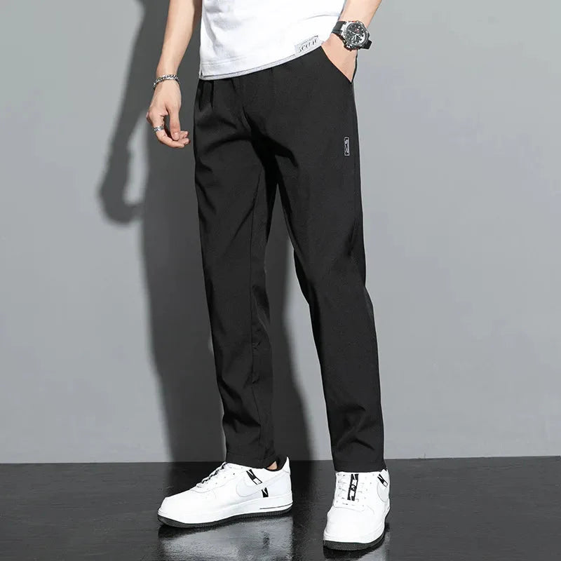 Man wearing black Slim Fit Stretch Jogger Pants with Elastic Waist, white sneakers, casual style