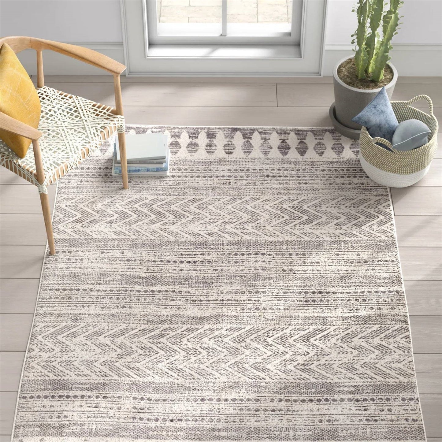 6.6-ft. x 9-ft. Grey Ivory Chevron Stripe Geometric Boho Style Area Rug in modern living room setting