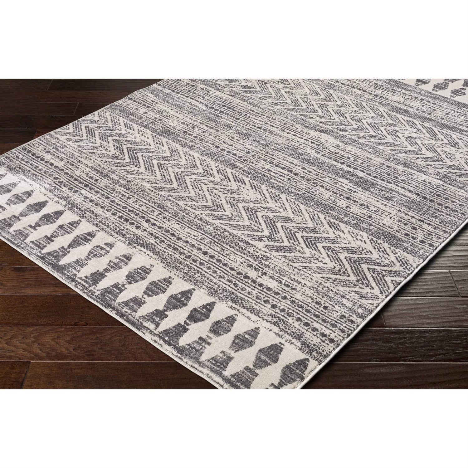6.6-ft. x 9-ft. Grey Ivory Chevron Stripe Geometric Boho Style Area Rug on dark wood floor