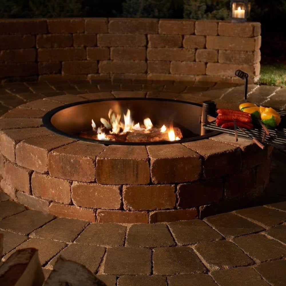 48-in Outdoor Round Concrete Block Stone Fire Pit Kit with Cooking Grill Grate in backyard setting with food grilling