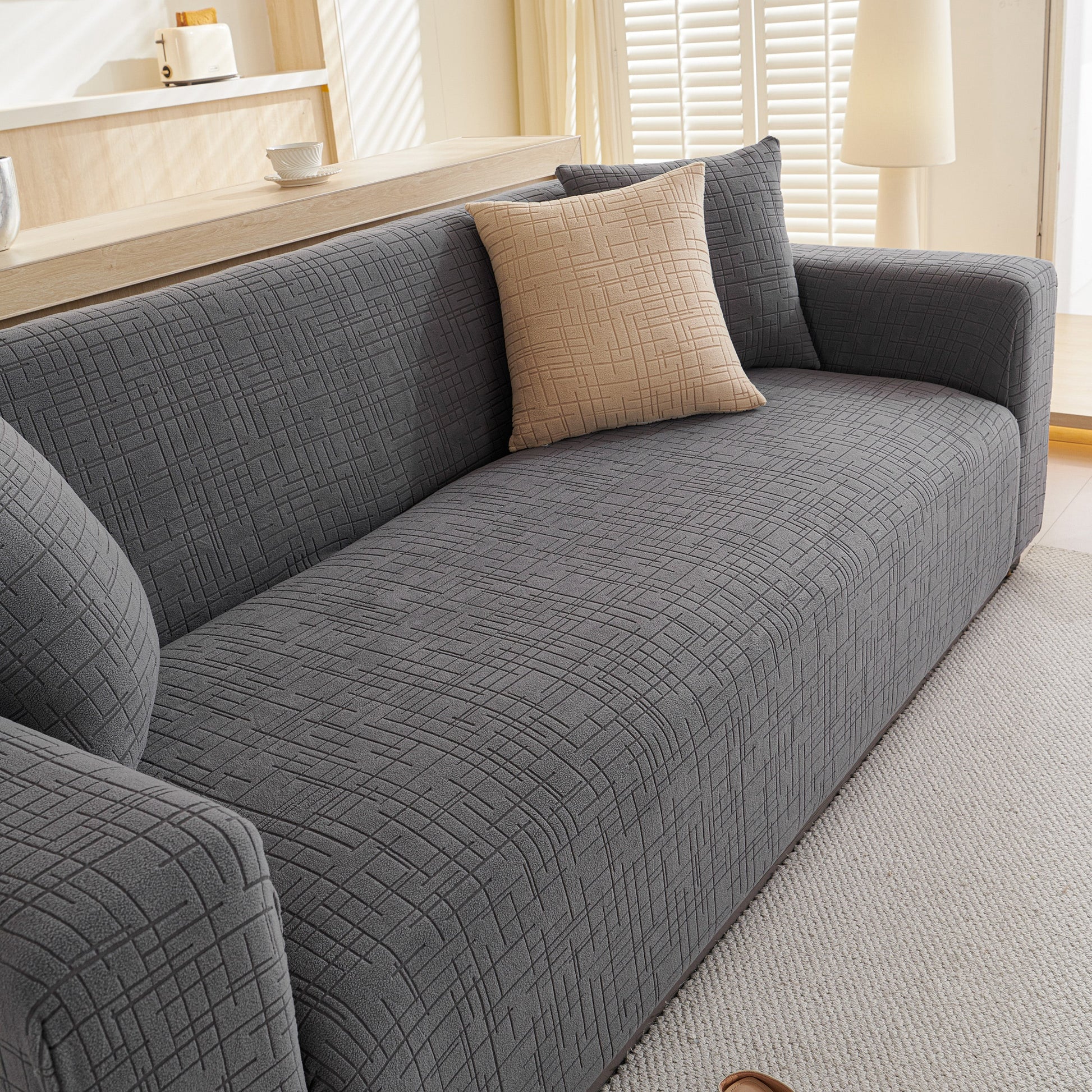 Embossed Lines Couch Covers Stretchable Non-Slip & Washable Sofa Slipcovers on a grey sofa