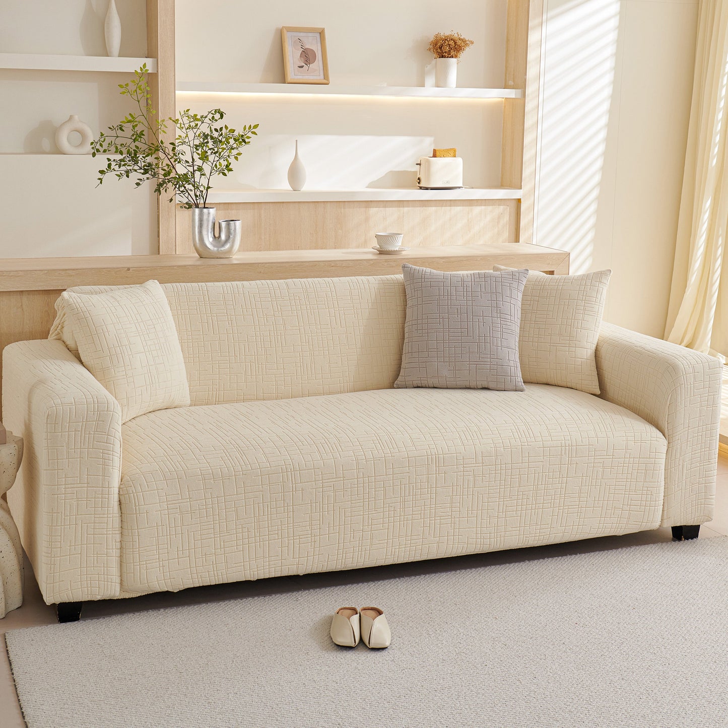 Embossed Lines Couch Covers Stretchable Non-Slip & Washable Sofa Slipcovers shown on a cream-colored couch in a modern living room setting.